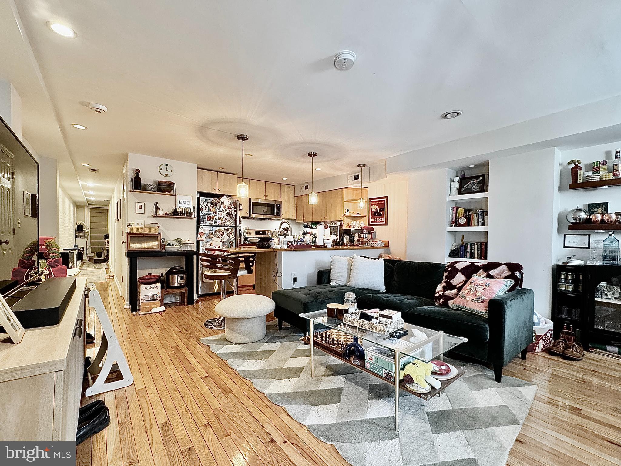 2017 13th Street Northwest, Unit B Washington, DC 20009 - Photo 3 of 15 a living room with lots of furniture and kitchen view