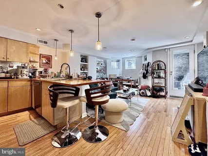 a living room with lots of furniture and kitchen view