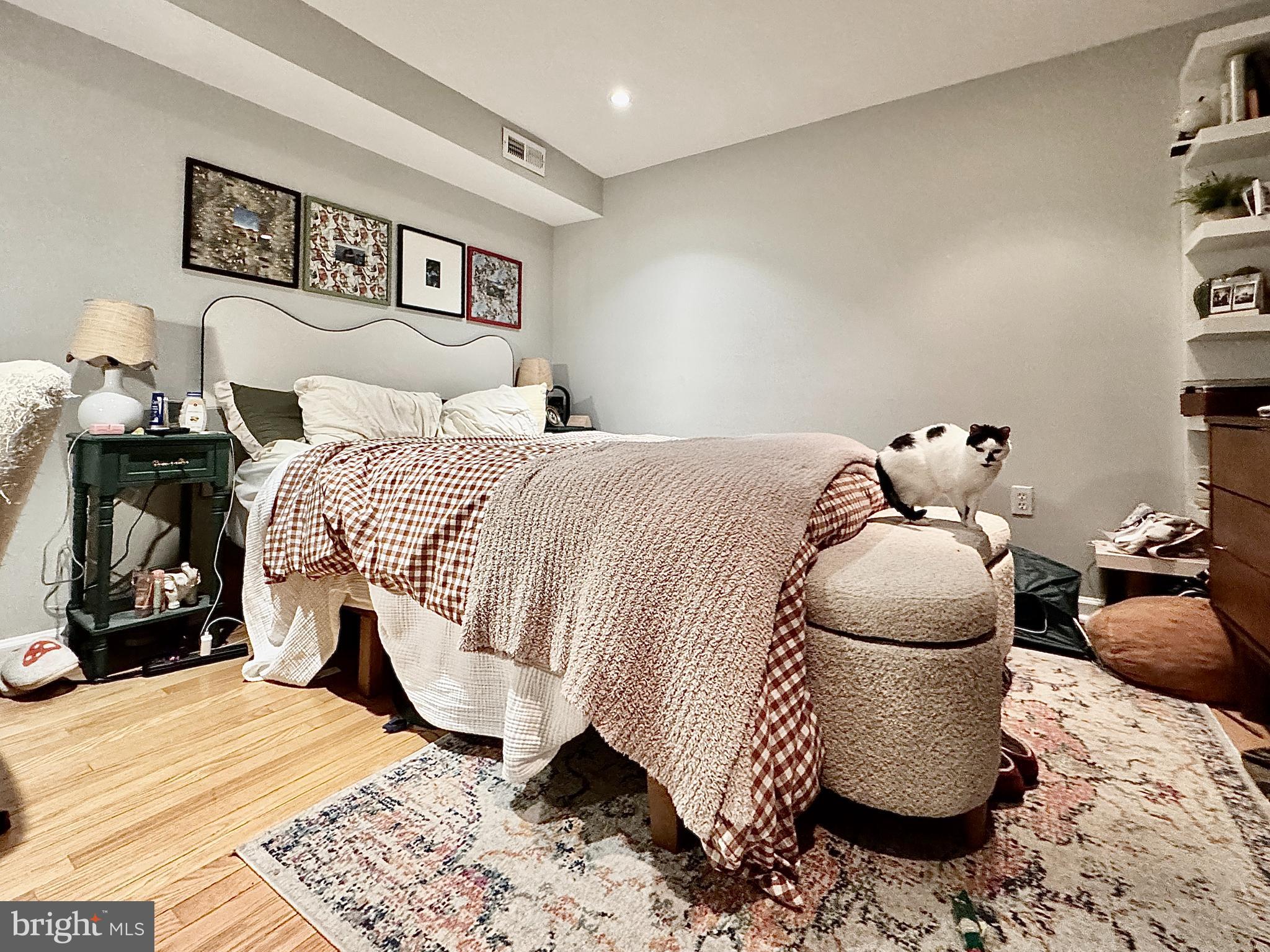 2017 13th Street Northwest, Unit B Washington, DC 20009 - Photo 9 of 15 a bedroom with a bed and wooden floor