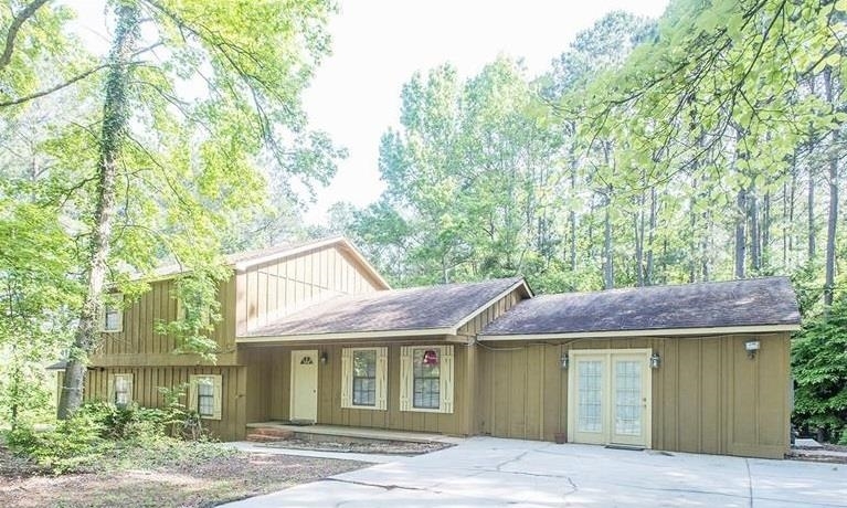 11449 Panhandle Road Hampton, GA 30228 - Photo 1 of 1 a front view of a house with a garden