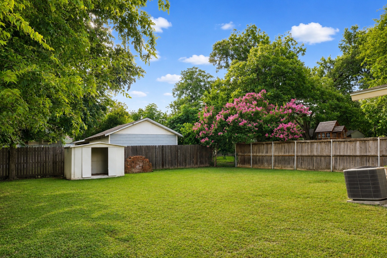 1508 Walnut Street Georgetown, TX 78626 - Photo 14 of 37 A spacious, well-maintained yard, perfect for outdoor activities, bordered by mature trees and a privacy fence.