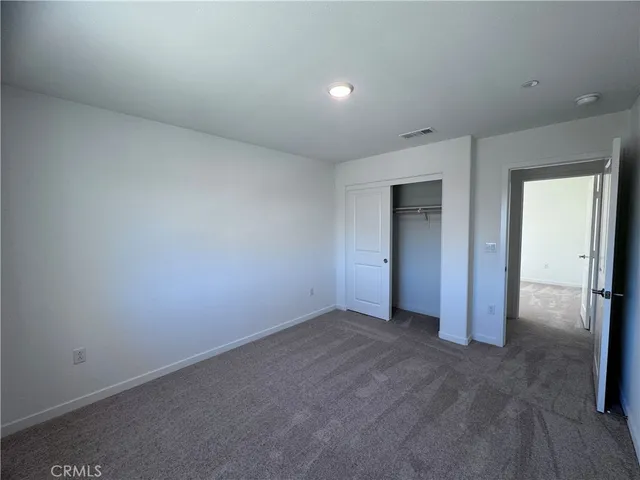 an empty room with closet area