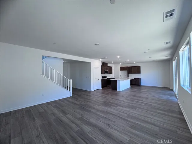 a view of kitchen and hall with wooden floor