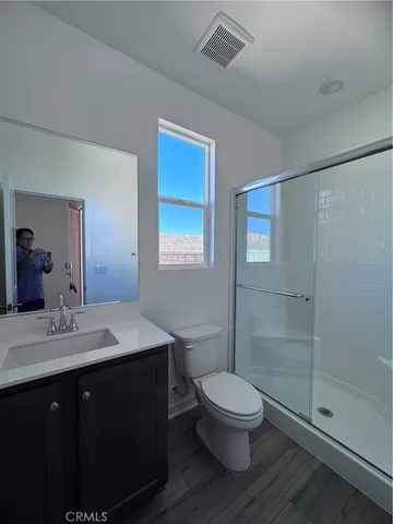 a bathroom with a toilet a sink and shower