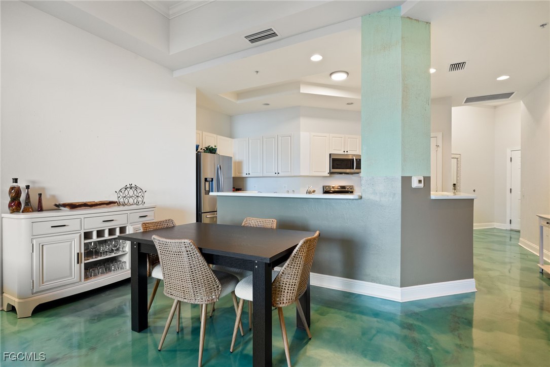 2743 First Street, Unit 304 Fort Myers, FL 33916 - Photo 14 of 50 a view of kitchen with cabinets table and chairs