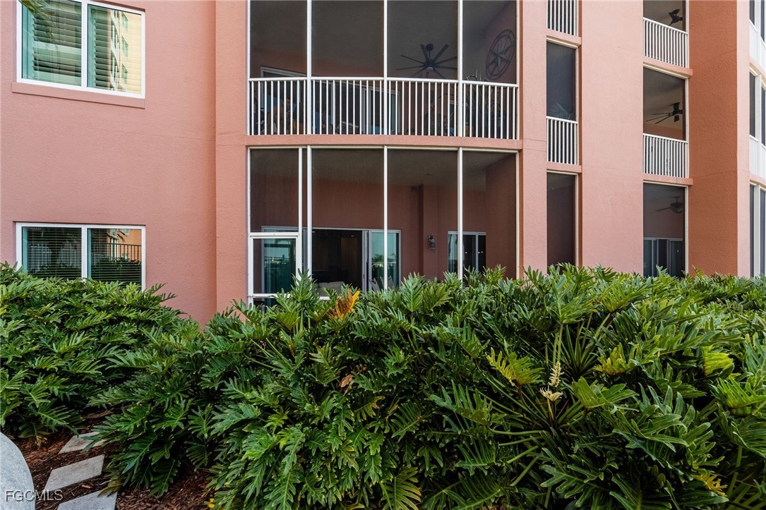 2743 First Street, Unit 304 Fort Myers, FL 33916 - Photo 20 of 50 a view of a house with a large window and potted plants