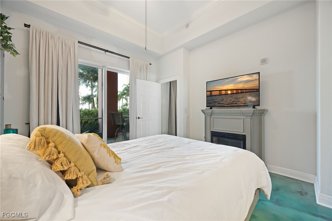 2743 First Street, Unit 304 Fort Myers, FL 33916 - Photo 22 of 50 a bedroom with a bed and a flat tv screen