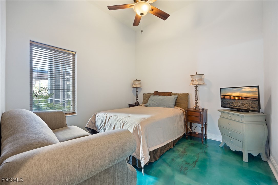 2743 First Street, Unit 304 Fort Myers, FL 33916 - Photo 29 of 50 a bedroom with bed couch and window