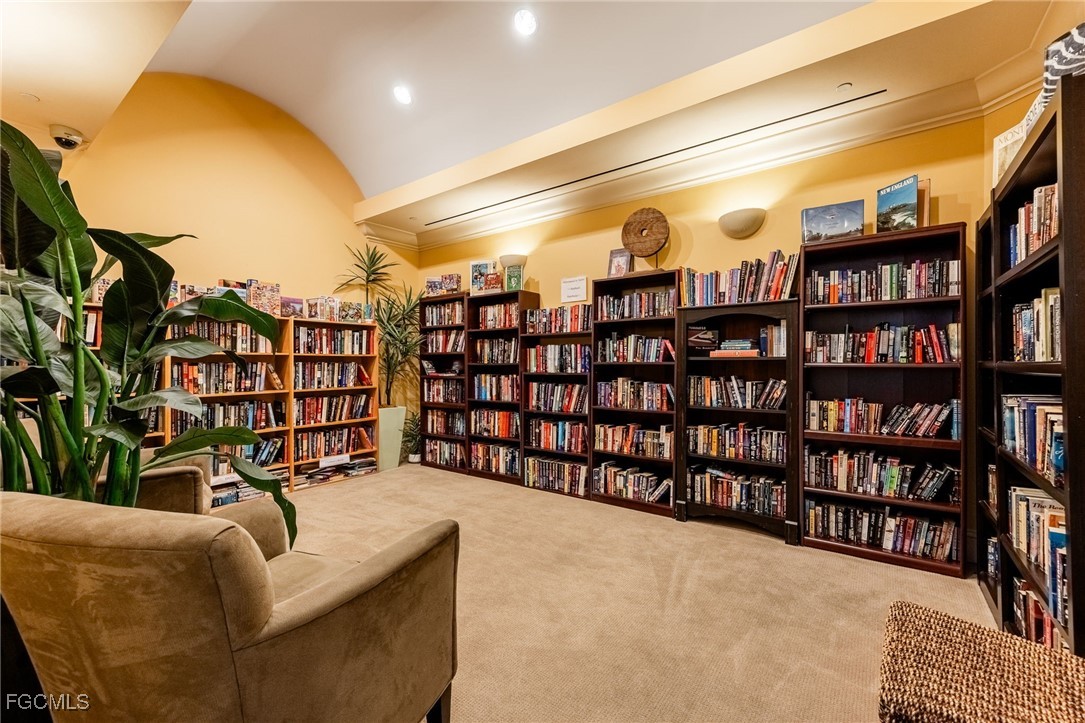 2743 First Street, Unit 304 Fort Myers, FL 33916 - Photo 44 of 50 a living room with furniture a bookshelf and a book shelf