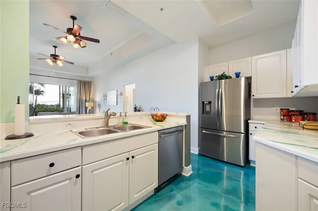 a kitchen with kitchen island a sink appliances and cabinets