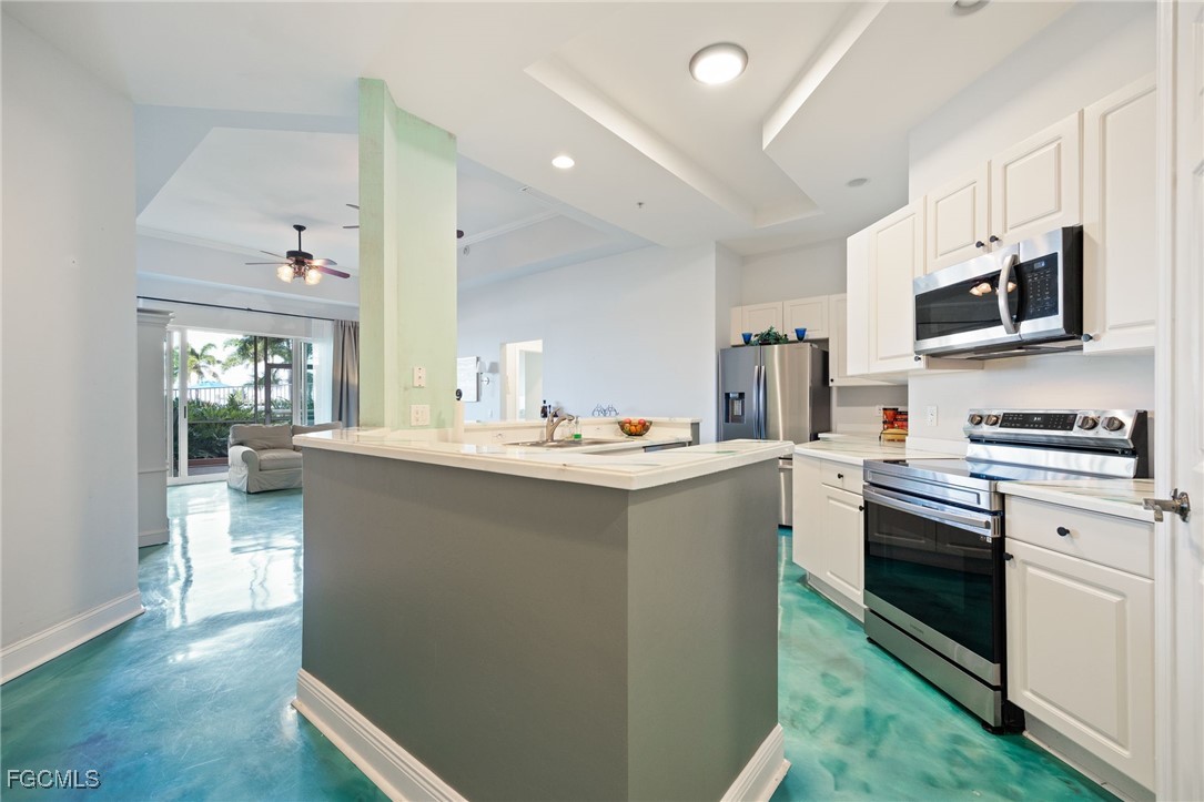 2743 First Street, Unit 304 Fort Myers, FL 33916 - Photo 8 of 50 a kitchen with stainless steel appliances a sink stove and cabinets