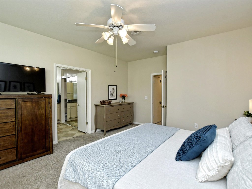 116 Running Water Street Georgetown, TX 78633 - Photo 17 of 25 a bedroom with a bed and a flat screen tv