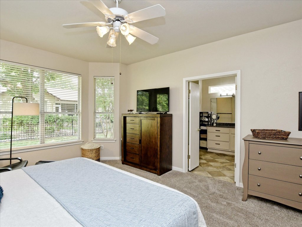 116 Running Water Street Georgetown, TX 78633 - Photo 18 of 25 a bedroom with a bed closet and flat tv screen