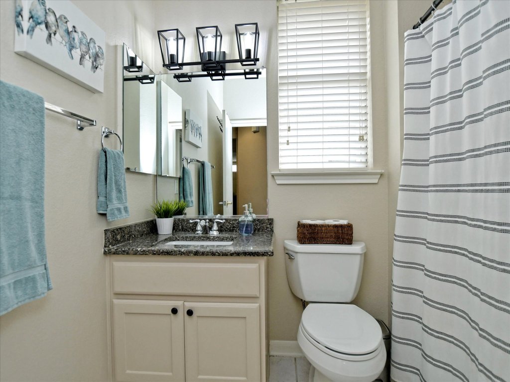 116 Running Water Street Georgetown, TX 78633 - Photo 22 of 25 a bathroom with a granite countertop toilet sink and mirror