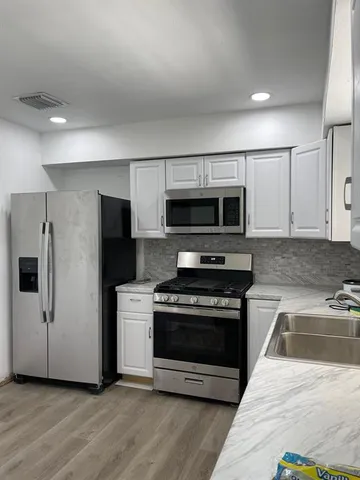 a kitchen with a stove a microwave and refrigerator