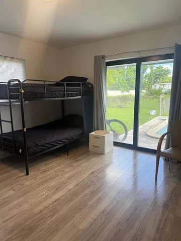 a bedroom with furniture and a floor to ceiling window