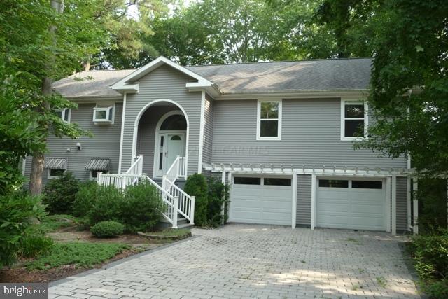 275 Windjammer Road Ocean Pines, MD 21811 - Photo 1 of 20 a front view of a house with garden