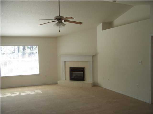 44 Shipwreck Road Santa Rosa Beach, FL 32459 - Photo 2 of 13 a view of an empty room with a fireplace and a window