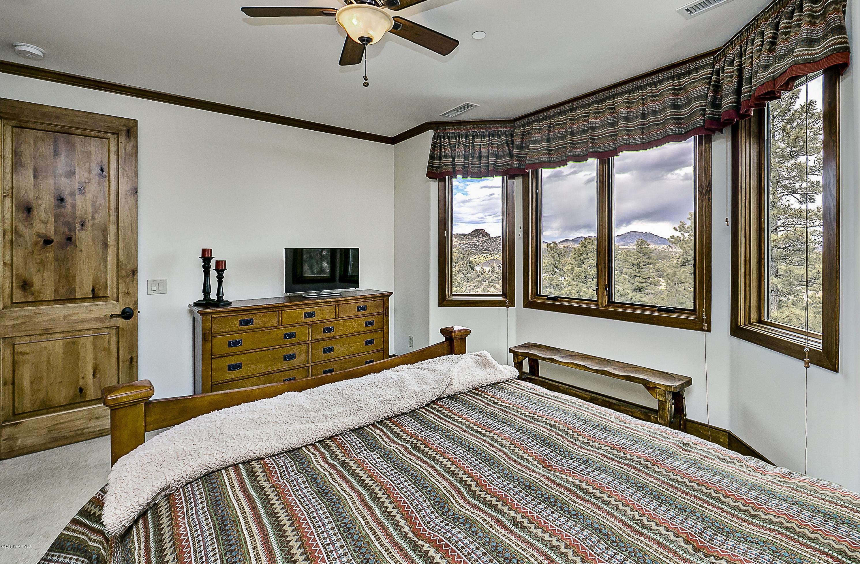 1340 East Valley View Road Prescott, AZ 86303 - Photo 19 of 33 a bedroom with a bed and large windows