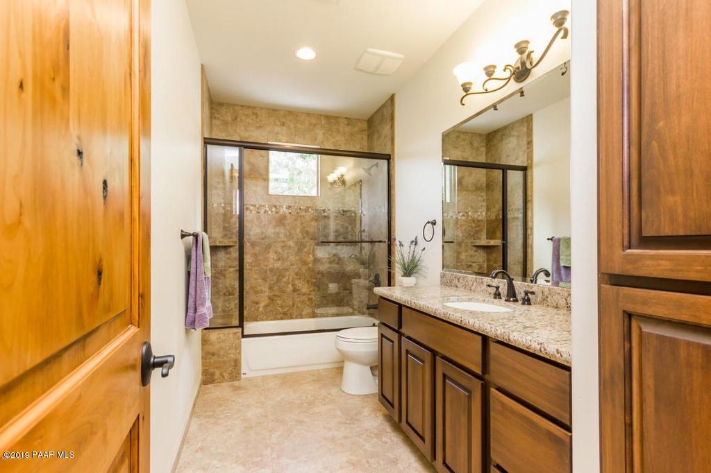 1340 East Valley View Road Prescott, AZ 86303 - Photo 21 of 33 a bathroom with a double vanity sink toilet mirror and shower