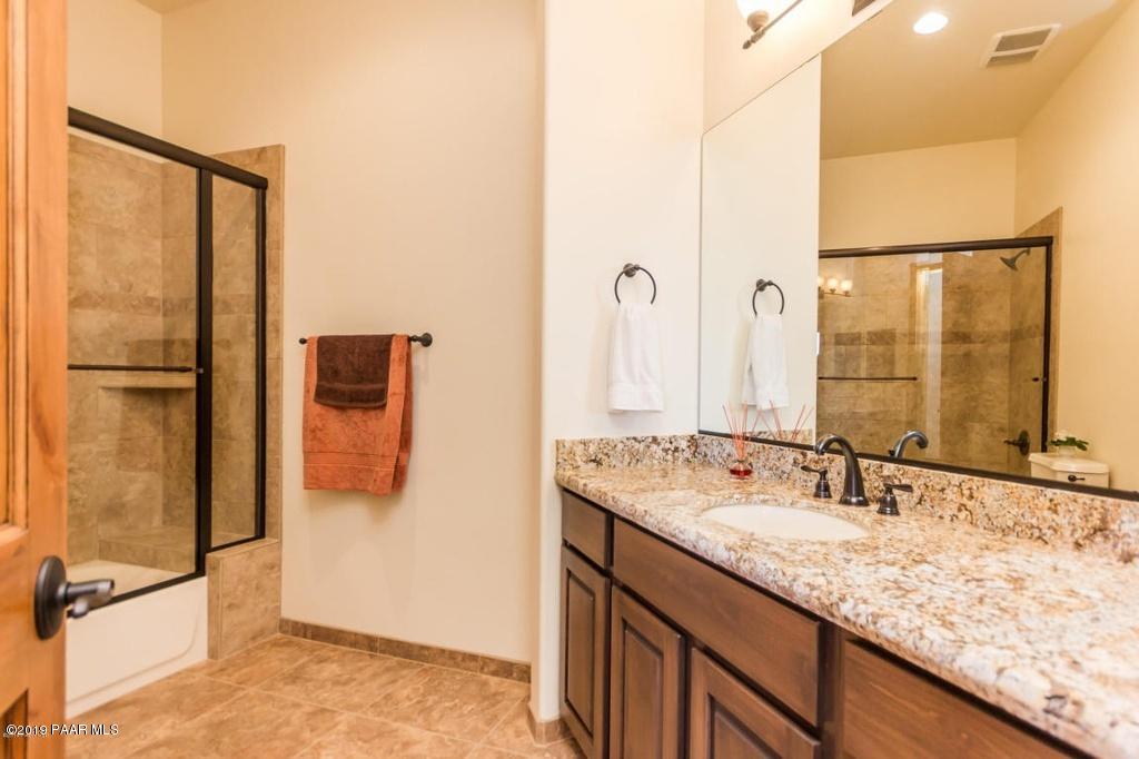 1340 East Valley View Road Prescott, AZ 86303 - Photo 24 of 33 a bathroom with a granite countertop sink and a mirror
