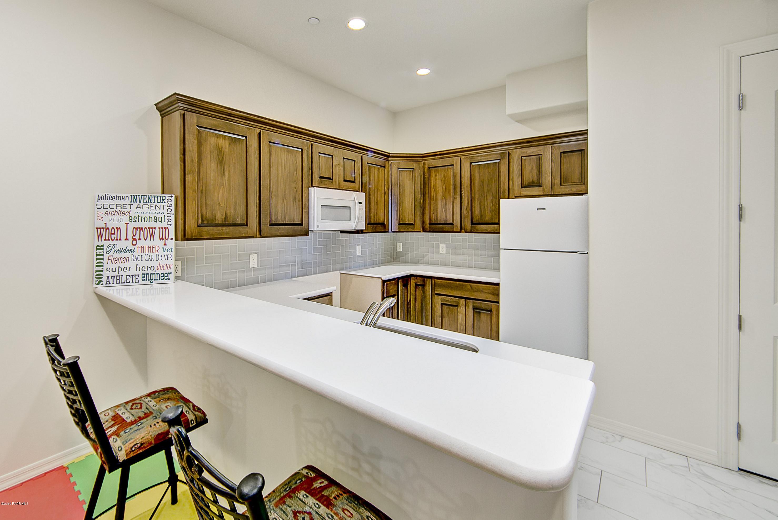1340 East Valley View Road Prescott, AZ 86303 - Photo 25 of 33 a kitchen with a refrigerator and a stove top oven