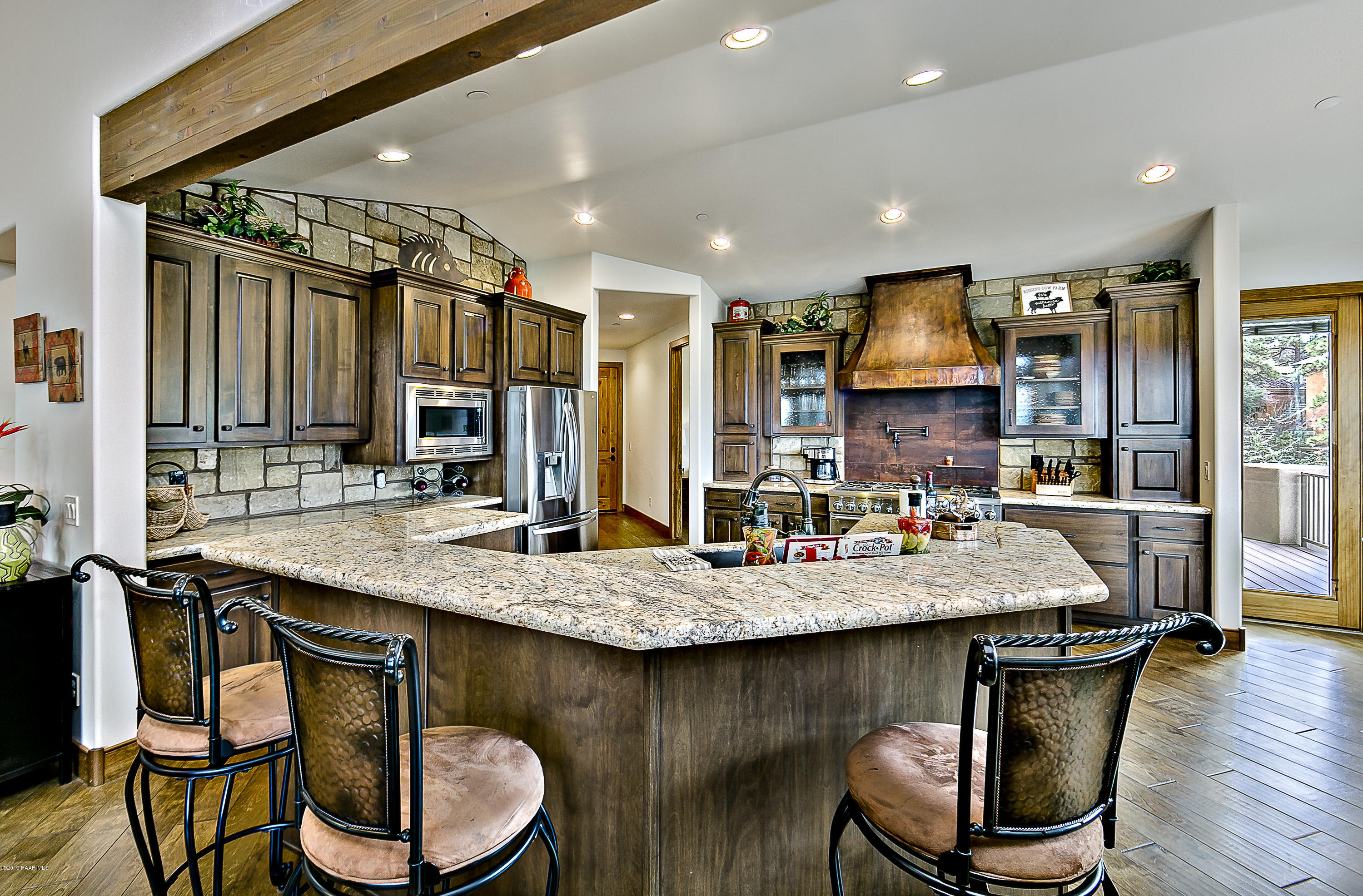 1340 East Valley View Road Prescott, AZ 86303 - Photo 7 of 33 a kitchen with stainless steel appliances granite countertop a table chairs sink refrigerator and cabinets