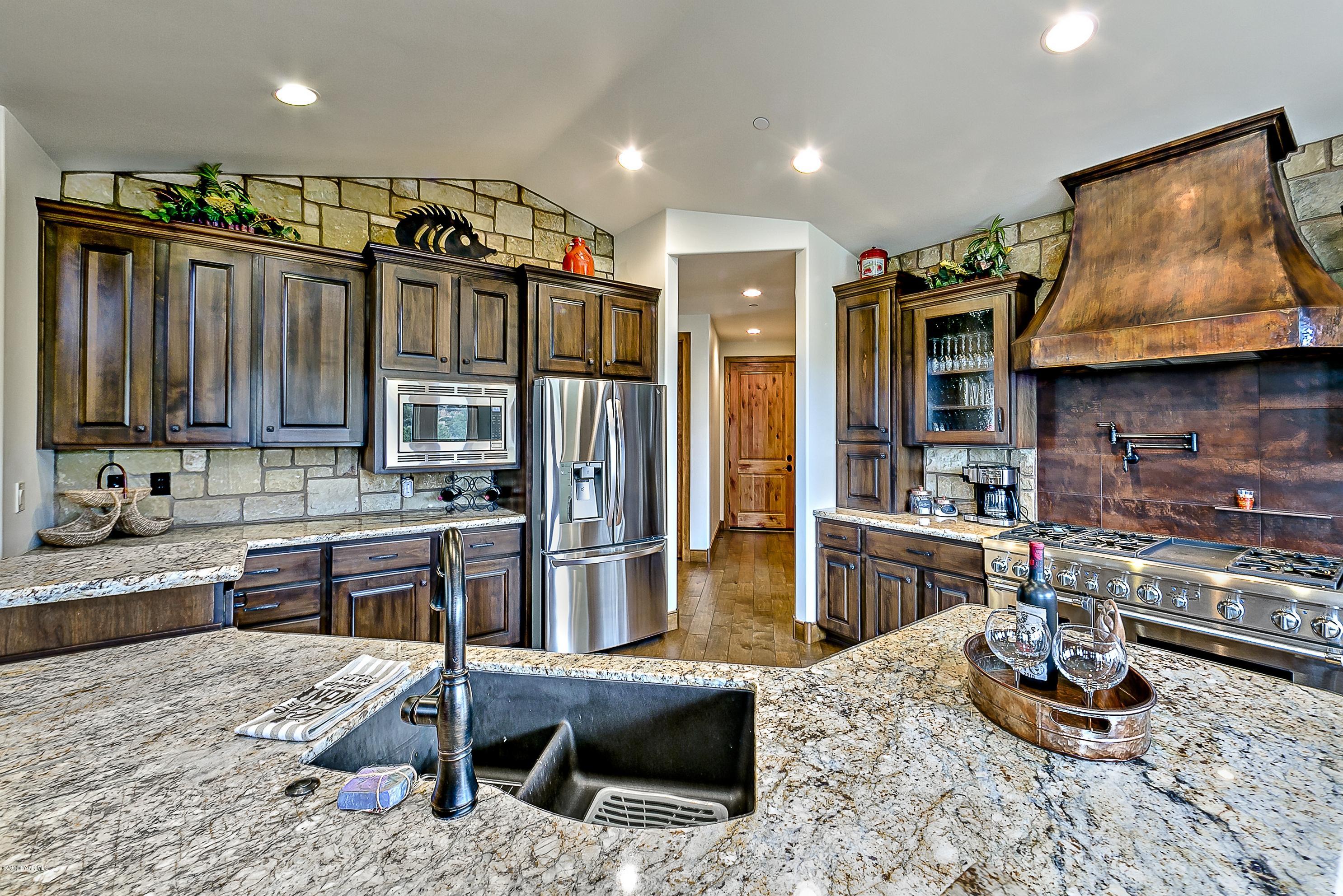 1340 East Valley View Road Prescott, AZ 86303 - Photo 8 of 33 a kitchen with stainless steel appliances kitchen island granite countertop a refrigerator and a stove top oven