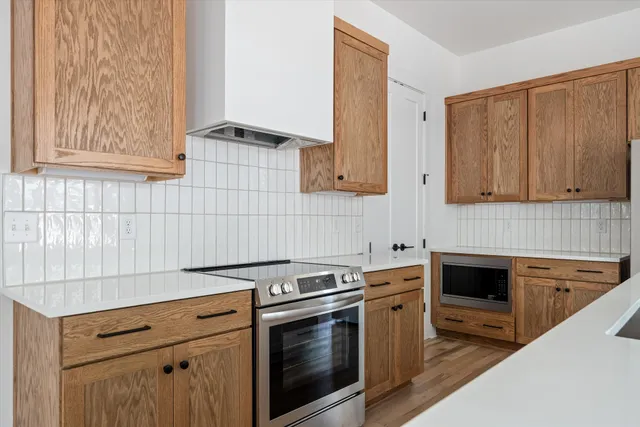 a kitchen with granite countertop cabinets stainless steel appliances and a counter space