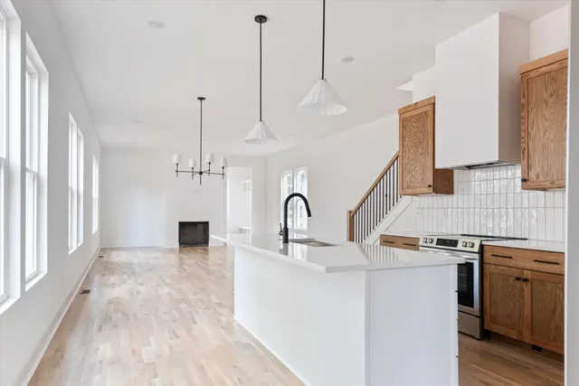 a kitchen with a sink and a stove top oven