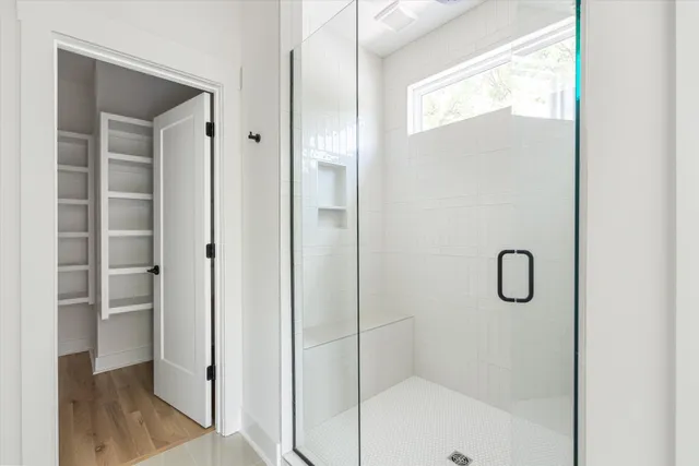 a bathroom with a glass shower door
