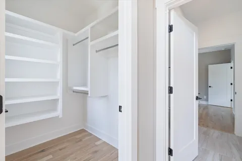 a view of a room with wooden floor