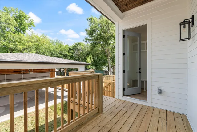 a view of a balcony with wooden floor