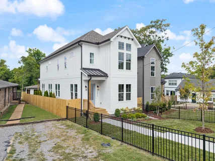 a view of a house with wooden fence