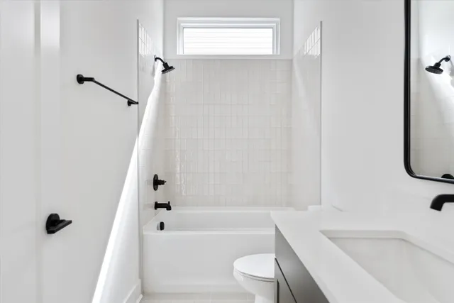 a bathroom with a bathtub toilet and sink