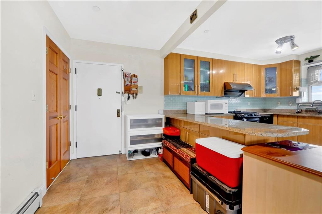 1270 Bay Ridge Parkway, Unit 6 Brooklyn, NY 11228 - Photo 11 of 24 a kitchen with stainless steel appliances granite countertop a stove and a refrigerator