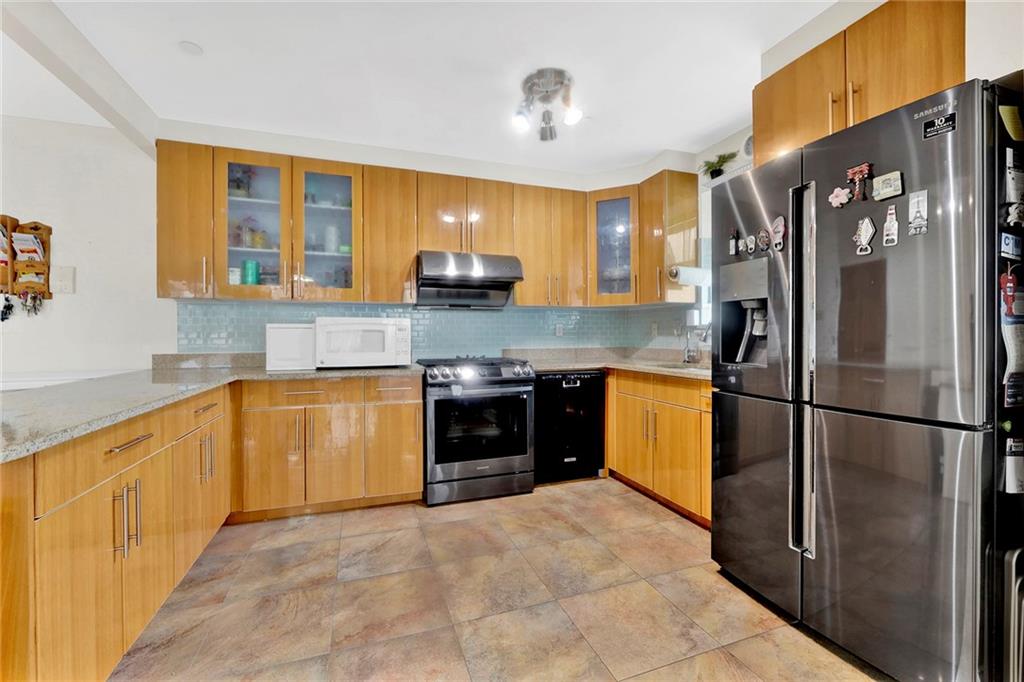 1270 Bay Ridge Parkway, Unit 6 Brooklyn, NY 11228 - Photo 12 of 24 a kitchen with stainless steel appliances granite countertop a refrigerator a stove and a sink