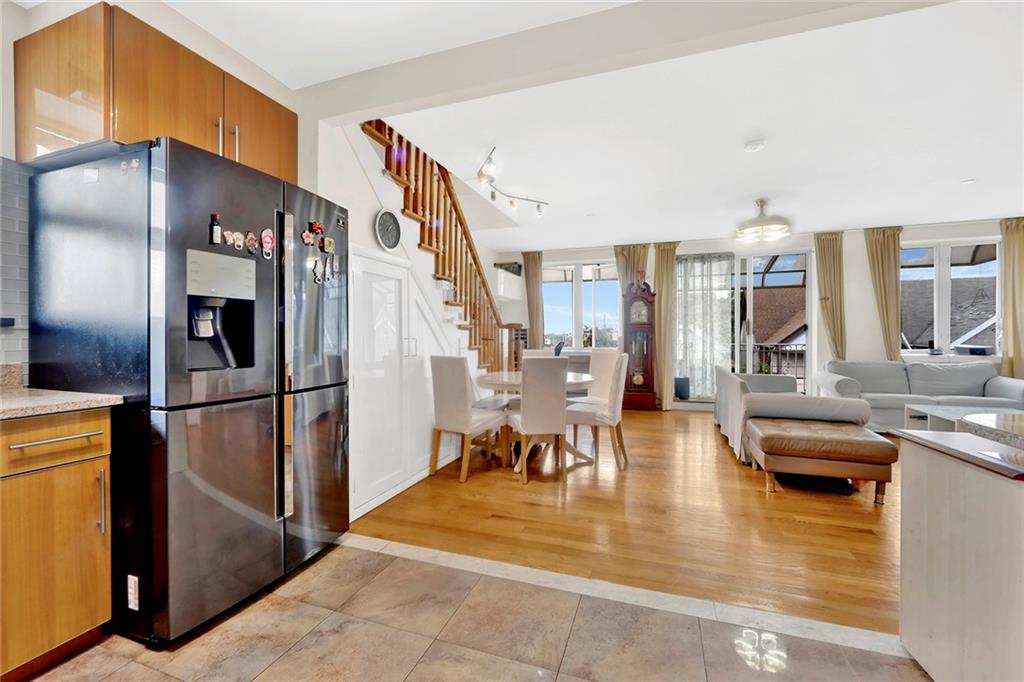 1270 Bay Ridge Parkway, Unit 6 Brooklyn, NY 11228 - Photo 13 of 24 a kitchen with stainless steel appliances kitchen island granite countertop a refrigerator a stove and a sink