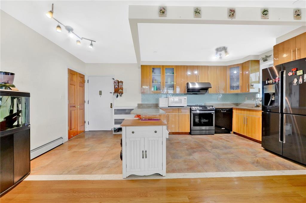 1270 Bay Ridge Parkway, Unit 6 Brooklyn, NY 11228 - Photo 14 of 24 a kitchen with stainless steel appliances granite countertop a refrigerator oven a sink dishwasher and white cabinets with wooden floor