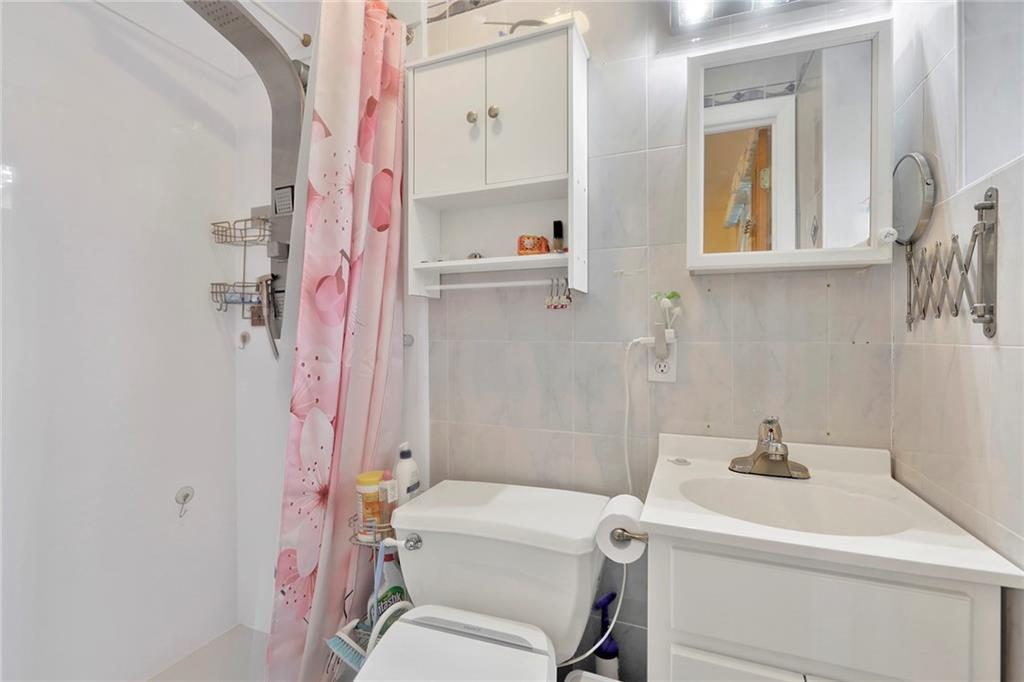 1270 Bay Ridge Parkway, Unit 6 Brooklyn, NY 11228 - Photo 15 of 24 a bathroom with a sink toilet and shower