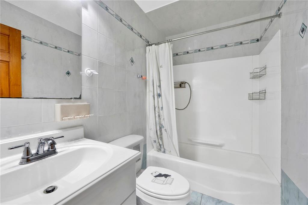 1270 Bay Ridge Parkway, Unit 6 Brooklyn, NY 11228 - Photo 16 of 24 a bathroom with a sink toilet tub and shower