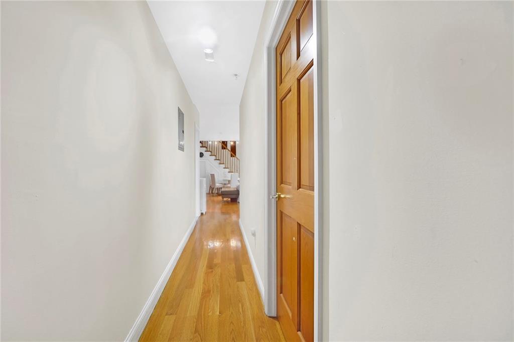 1270 Bay Ridge Parkway, Unit 6 Brooklyn, NY 11228 - Photo 17 of 24 a hallway with wooden floor and a bathroom