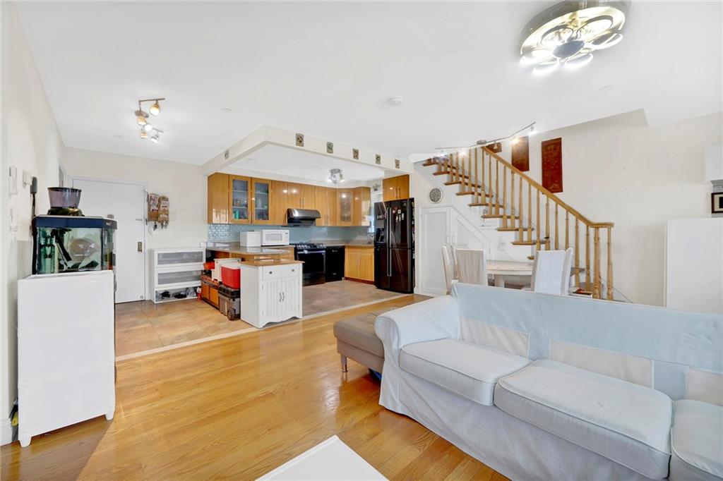 1270 Bay Ridge Parkway, Unit 6 Brooklyn, NY 11228 - Photo 6 of 24 a living room with furniture and a kitchen view