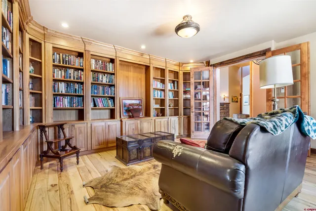 a living room with furniture and a book shelf