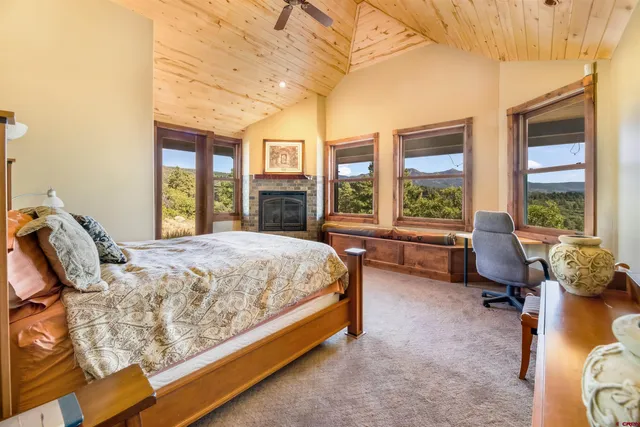 a bed sitting in a spacious bedroom next to a window