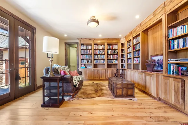 a living room with lots of furniture and a book shelf