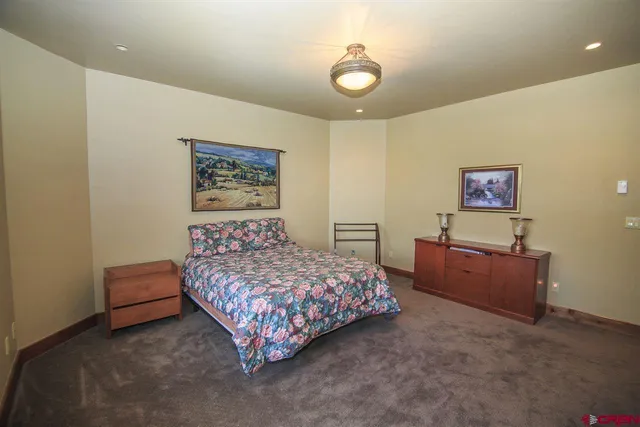 a bed room with a bed and painting on the wall