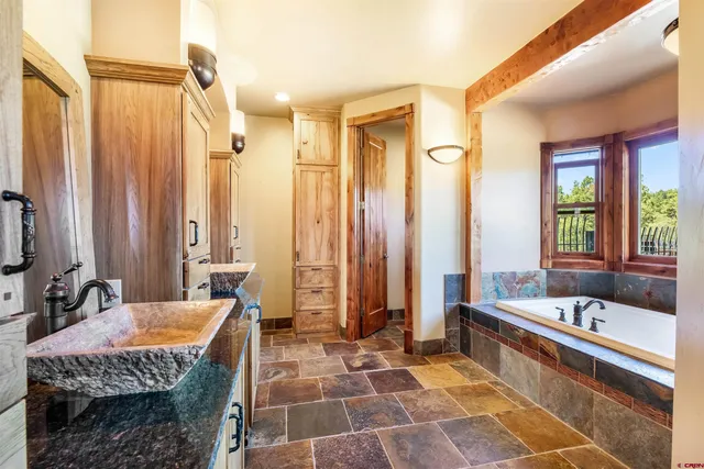 a spacious bathroom with a tub and a sink