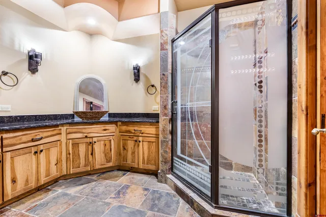 a spacious bathroom with a mirror a sink and glass door