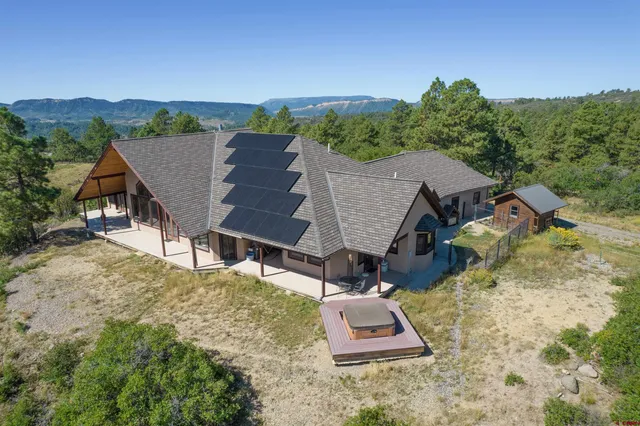 an aerial view of a house with a yard
